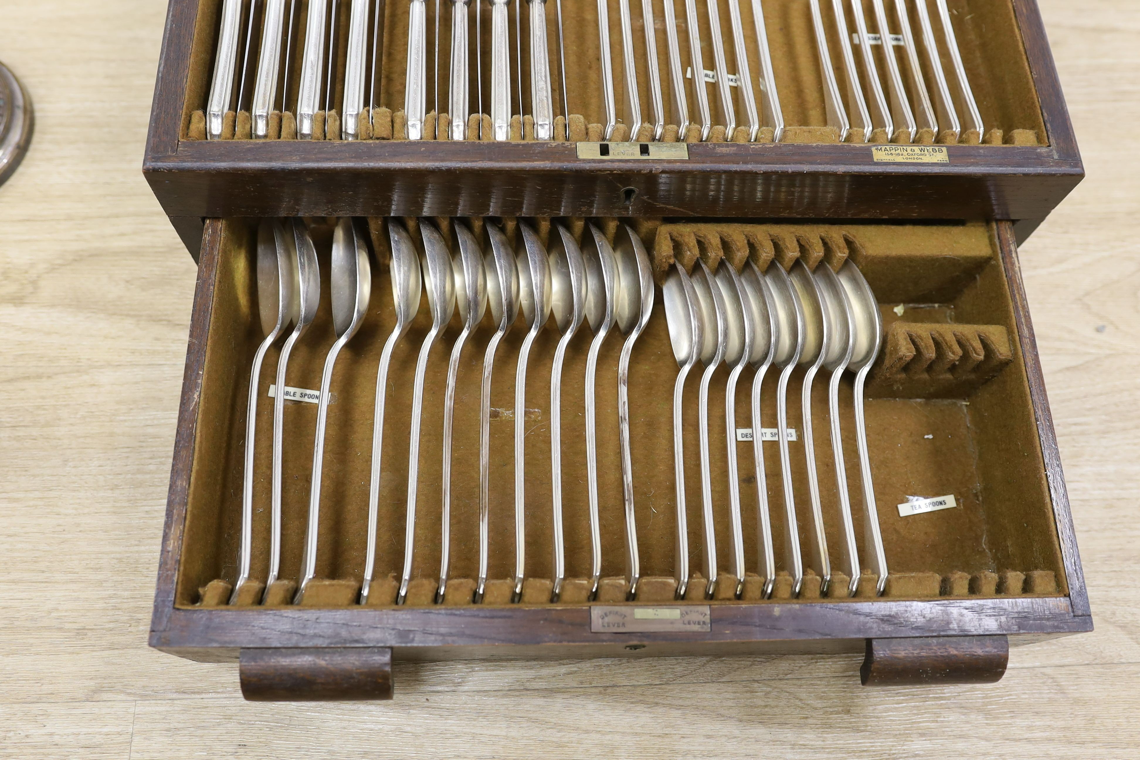 A pair of plated telescopic candlesticks and a Mappin & Webb part canteen of plated cutlery